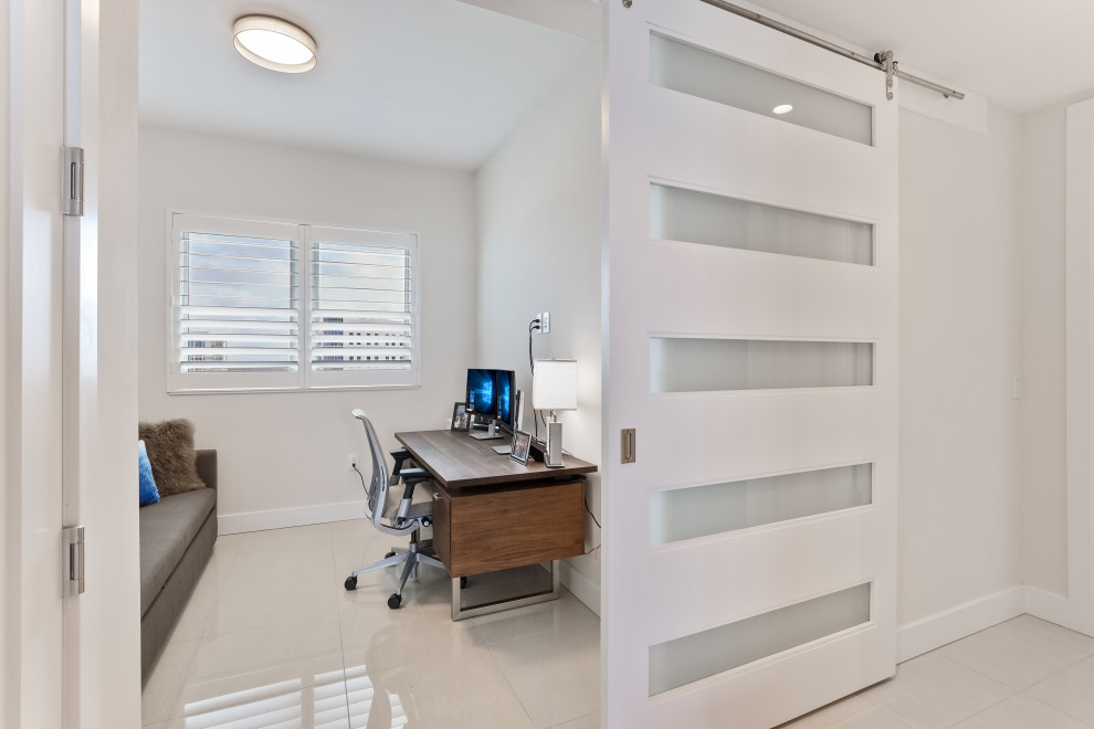 Design ideas for a transitional study room in Tampa with grey walls, porcelain floors, a freestanding desk and white floor.
