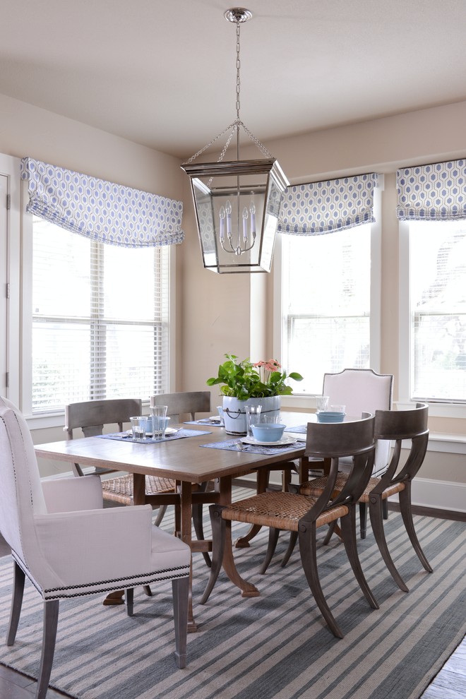 This is an example of a transitional dining room in Austin with beige walls.