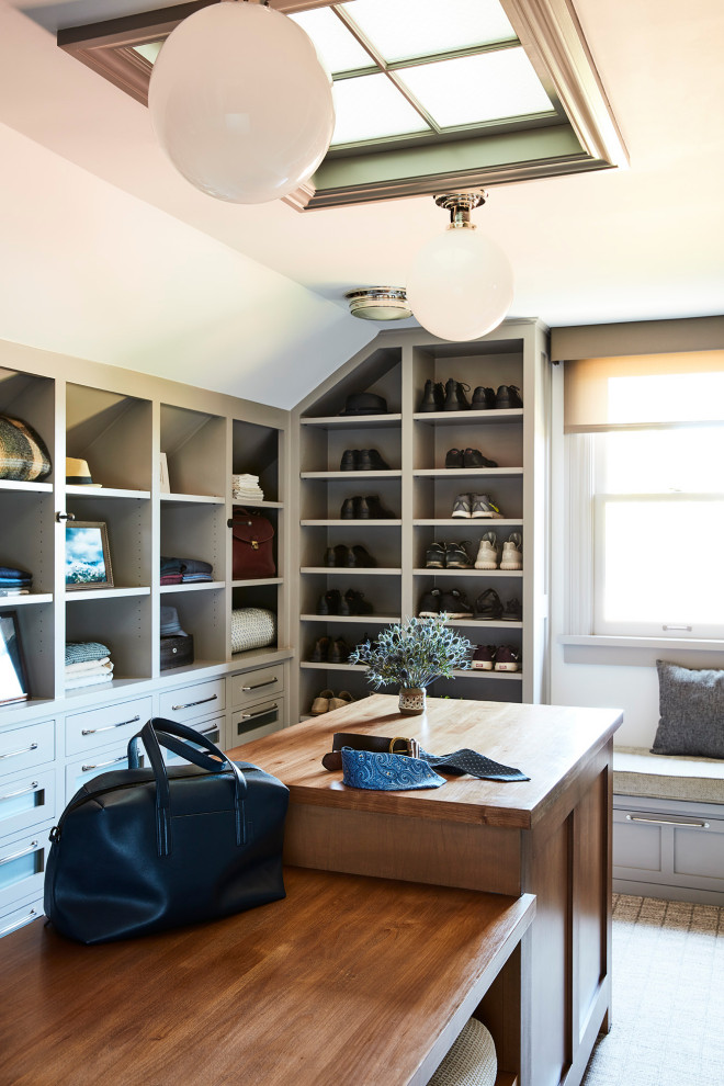 Inspiration for a beach style men's walk-in wardrobe in Los Angeles with beige cabinets.