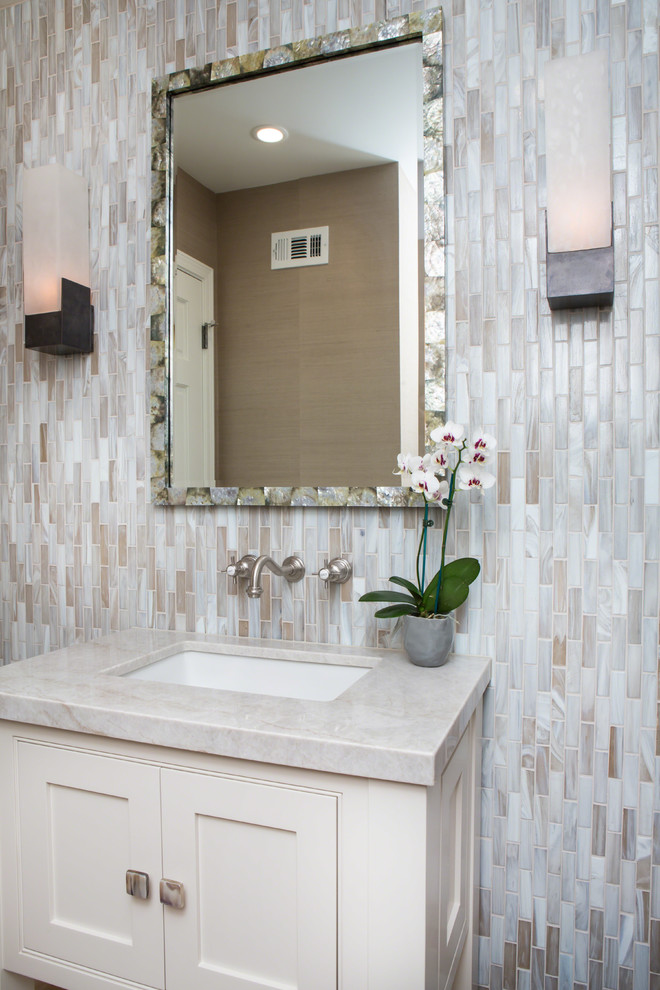 Design ideas for a small transitional powder room in Los Angeles with shaker cabinets, beige cabinets, a one-piece toilet, multi-coloured tile, glass tile, beige walls, a drop-in sink and quartzite benchtops.