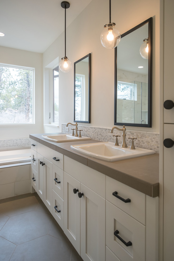 Drop-in bathtub - mid-sized transitional master porcelain tile porcelain tile drop-in bathtub idea with a drop-in sink, shaker cabinets, white cabinets and tile countertops