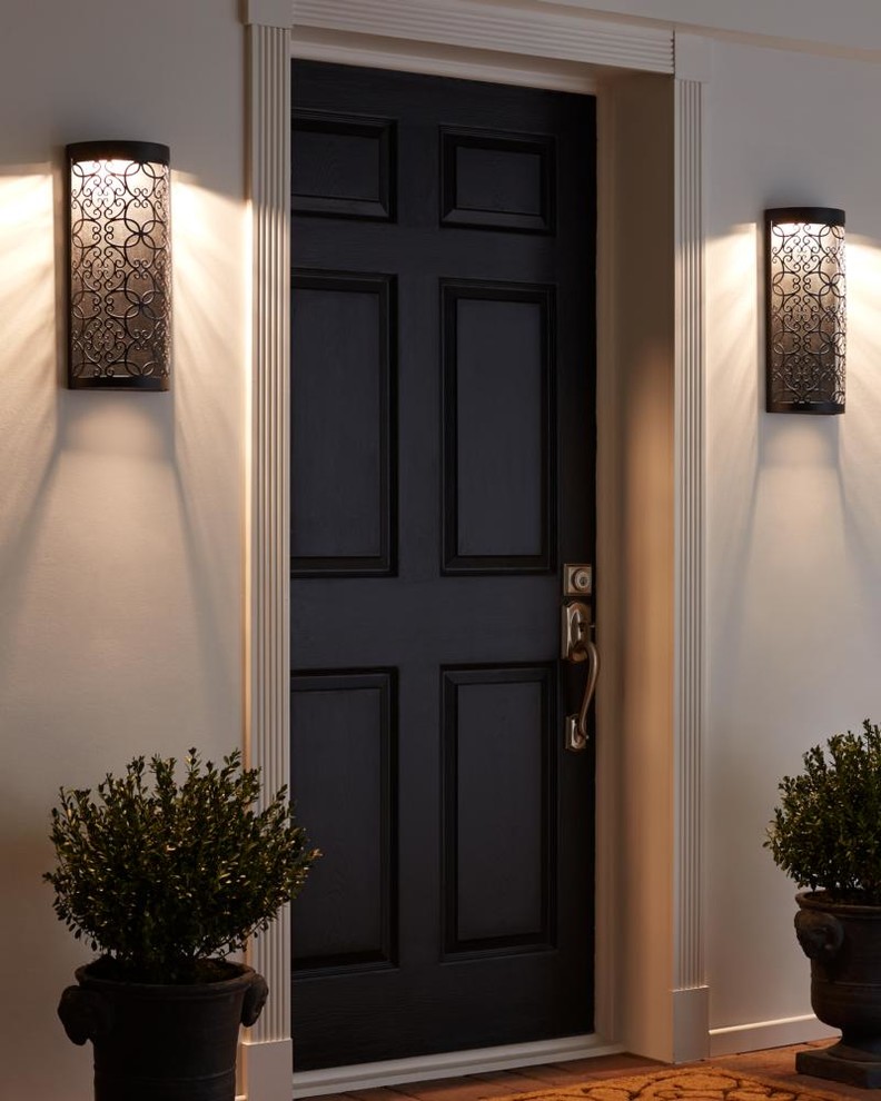 Inspiration for a mid-sized transitional medium tone wood floor single front door remodel with gray walls and a black front door