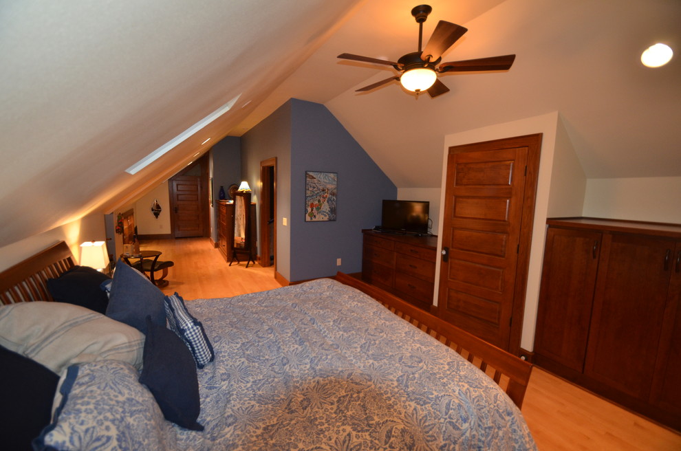 Inspiration for a large transitional master light wood floor bedroom remodel with blue walls