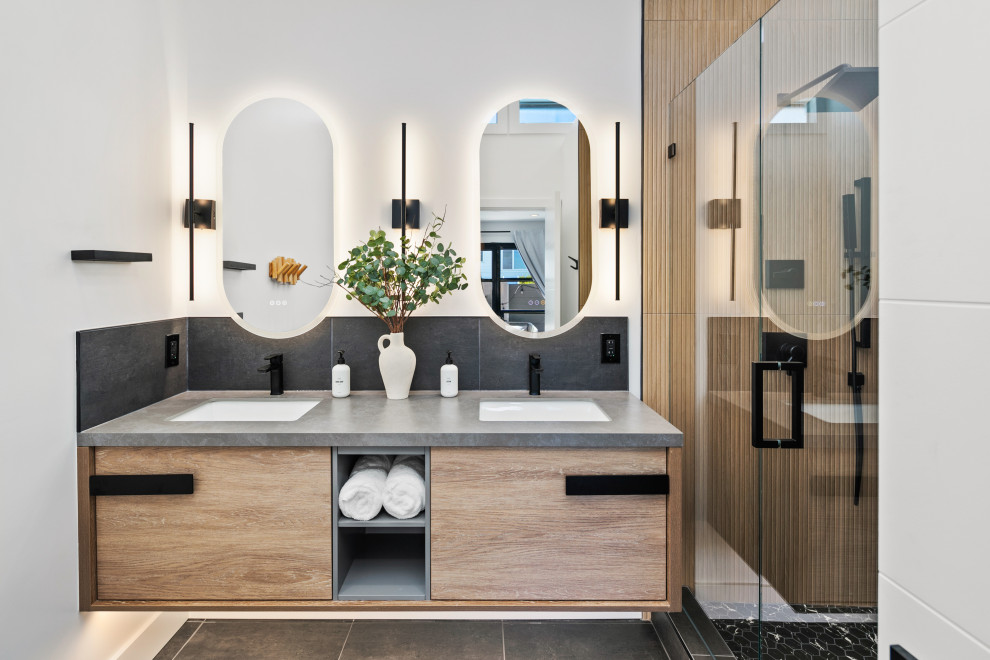 Inspiration for a contemporary shower room bathroom in San Diego with flat-panel cabinets, medium wood cabinets, an alcove shower, beige tiles, white walls, a submerged sink, grey floors, a hinged door, grey worktops, double sinks and a floating vanity unit.