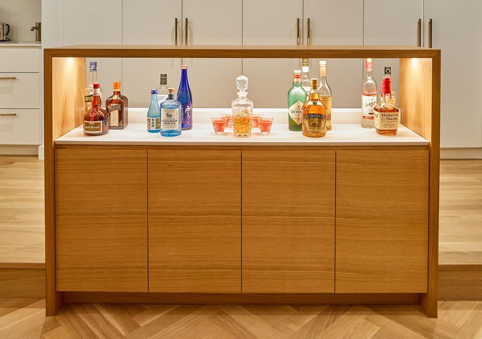 Inspiration for a mid-sized scandinavian single-wall wet bar in Toronto with no sink, flat-panel cabinets, light wood cabinets, wood benchtops, light hardwood floors, brown floor and brown benchtop.