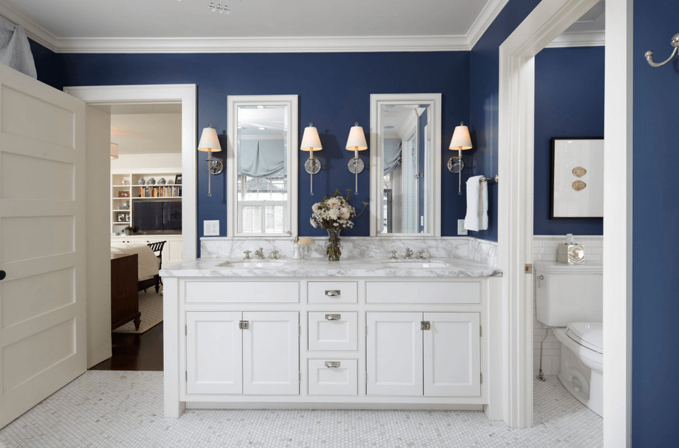 Bathroom in Las Vegas with white cabinets and marble benchtops.