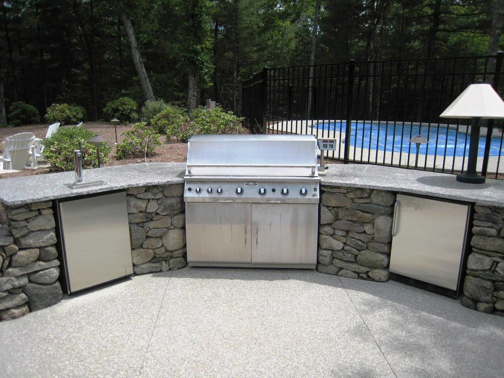 Example of a mid-sized transitional backyard concrete patio kitchen design in Providence with no cover