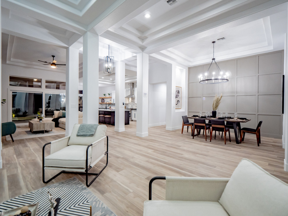 Große Moderne Wohnküche ohne Kamin mit weißer Wandfarbe, braunem Boden, eingelassener Decke und Vinylboden in Las Vegas