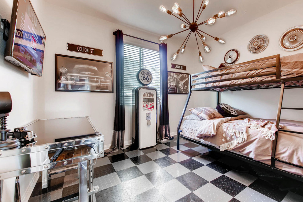 Modern Farmhouse - Super cool vintage car themed boys bedroom with an industrial sputnik light fixture, retro bunk beds, garage flooring, and vintage gasoline pump gumball machine.