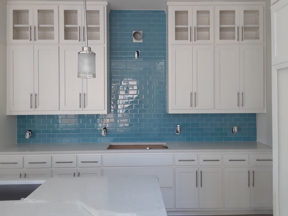 Kitchen - kitchen idea in Austin with shaker cabinets, white cabinets, quartz countertops, blue backsplash, ceramic backsplash and white countertops