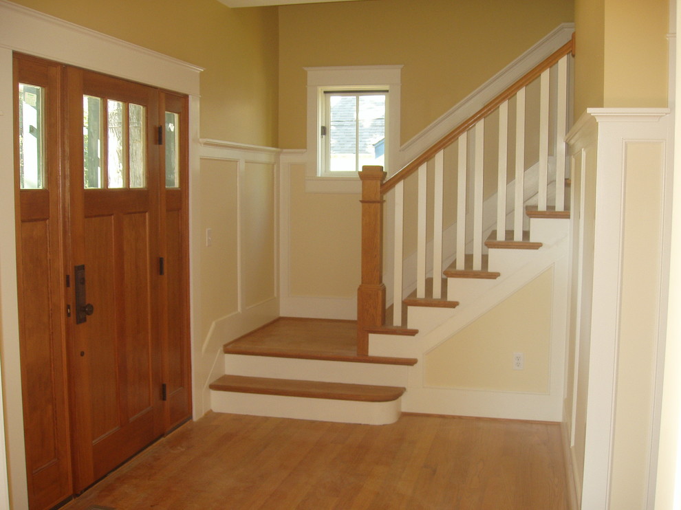 This is an example of a mid-sized arts and crafts wood l-shaped staircase in Baltimore with painted wood risers.