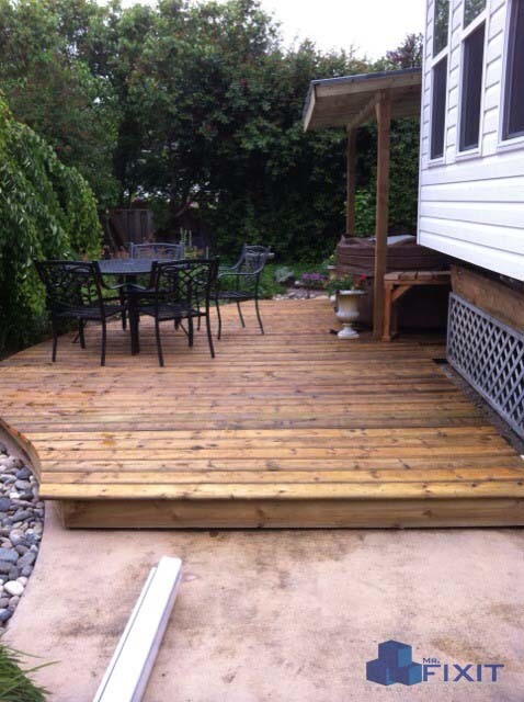 This is an example of a small country backyard patio in Vancouver with concrete slab and a roof extension.