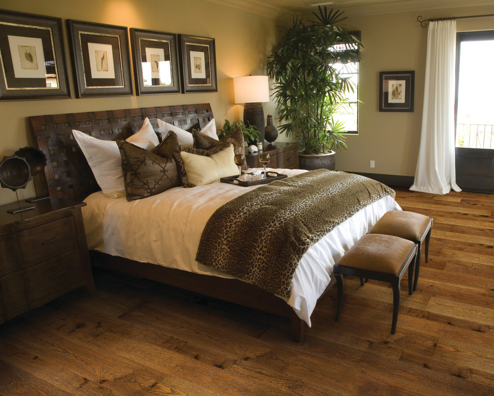 Large contemporary master bedroom in Denver with beige walls, medium hardwood floors, no fireplace and beige floor.