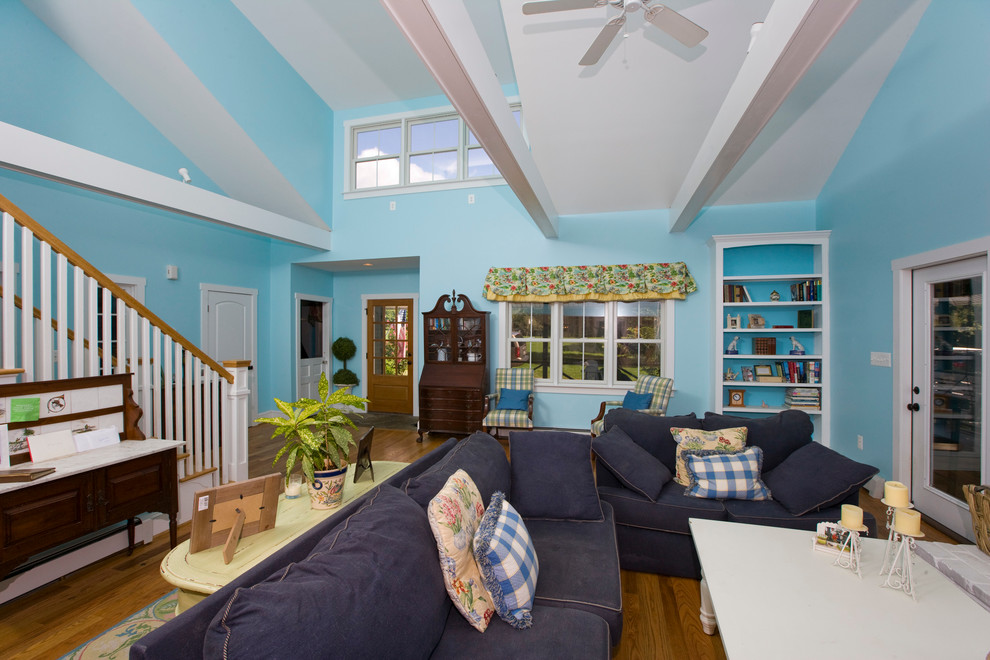 This is an example of a large traditional formal open concept living room in Baltimore with blue walls, medium hardwood floors, no tv, a standard fireplace and a brick fireplace surround.