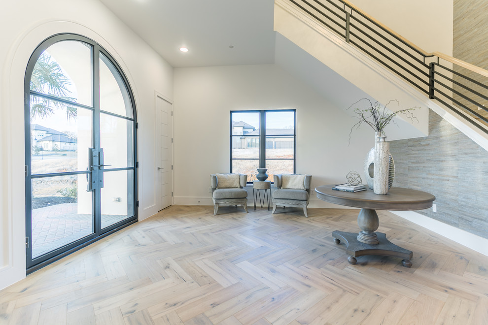 This is an example of a large transitional foyer in Dallas with white walls, medium hardwood floors, a single front door, a metal front door and multi-coloured floor.