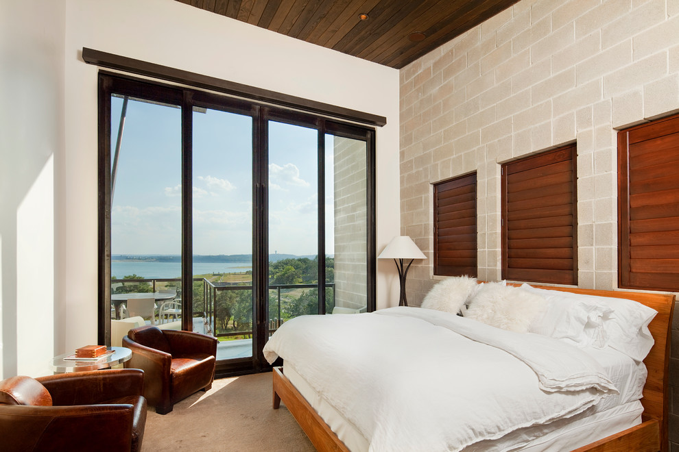 Contemporary bedroom in Austin with beige walls.