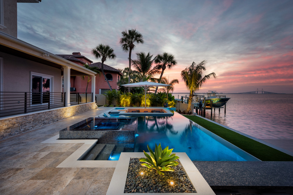 Inspiration for a contemporary backyard rectangular pool in Tampa with a hot tub and tile.