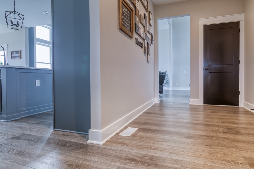 Hallway - mid-sized 1950s vinyl floor and brown floor hallway idea in Other with beige walls