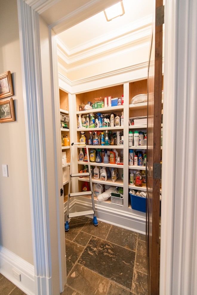 Mid-sized traditional kitchen pantry in New York with open cabinets, white cabinets and porcelain floors.