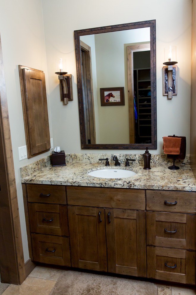 Inspiration for a mid-sized rustic 3/4 brown tile and porcelain tile alcove shower remodel in Phoenix with beige walls, an undermount sink, a hinged shower door, shaker cabinets, medium tone wood cabinets, granite countertops and multicolored countertops