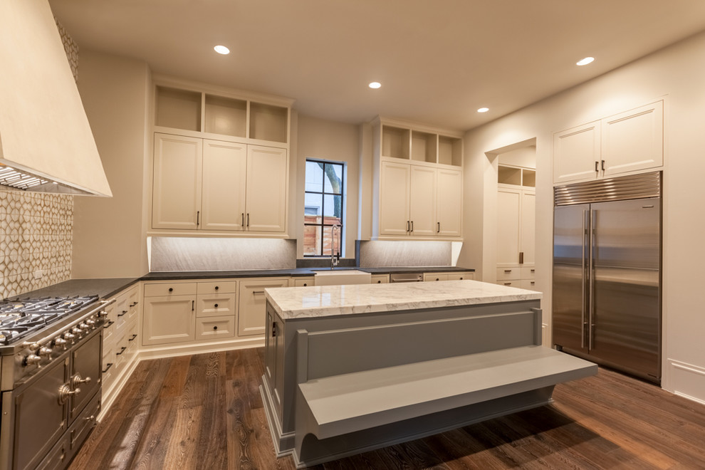 Example of a large transitional l-shaped medium tone wood floor eat-in kitchen design in Houston with recessed-panel cabinets, marble countertops, beige backsplash, stainless steel appliances and an island