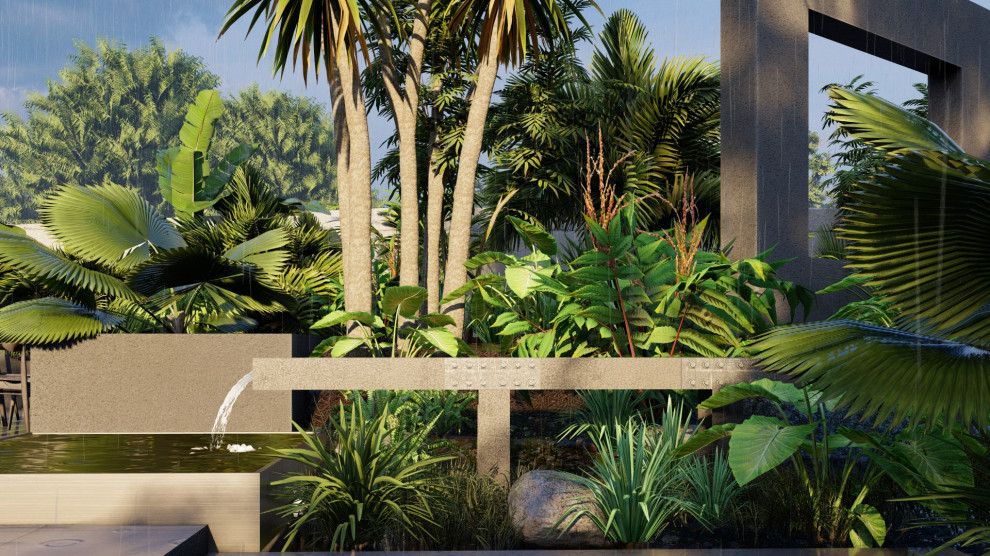 Ispirazione per un grande giardino formale tropicale esposto a mezz'ombra dietro casa in estate con fontane, pavimentazioni in cemento e recinzione in pietra