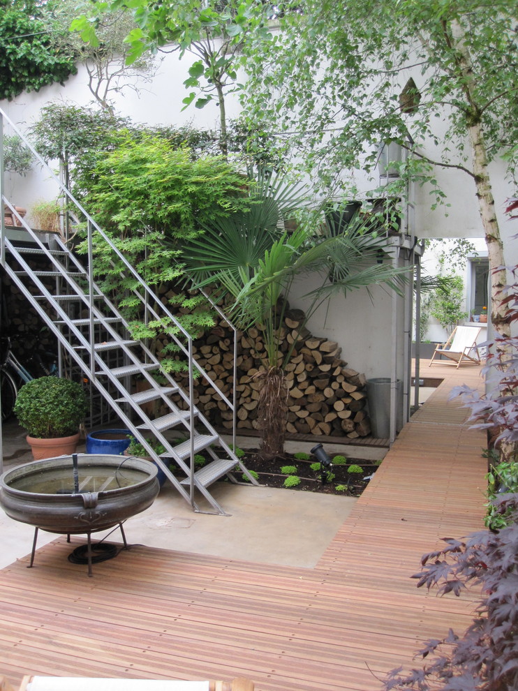 Large industrial deck in Paris with a water feature.