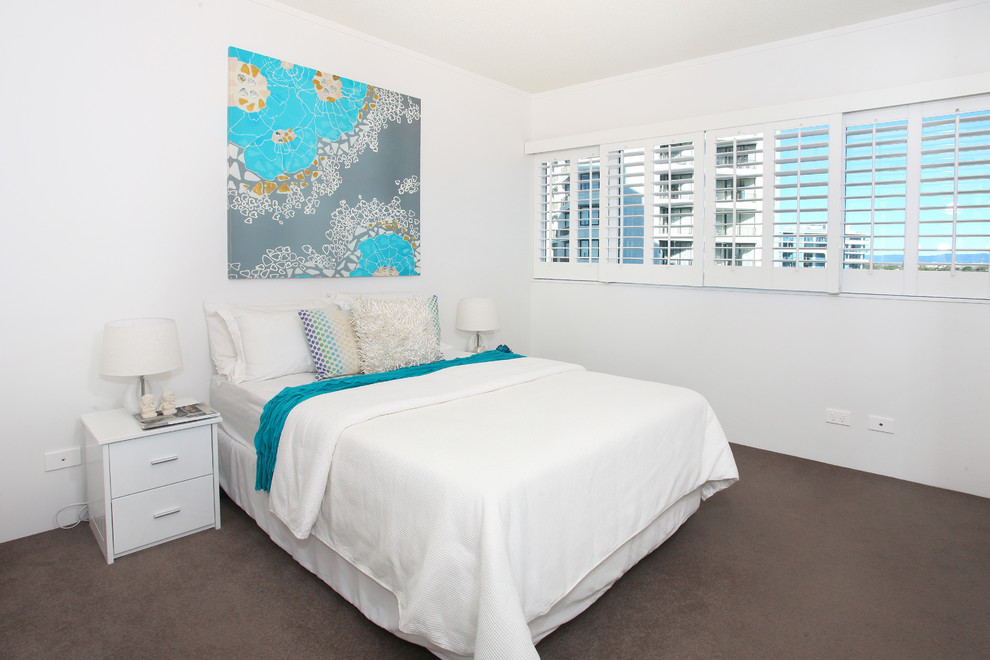 Mid-sized beach style guest bedroom in Gold Coast - Tweed with white walls and carpet.