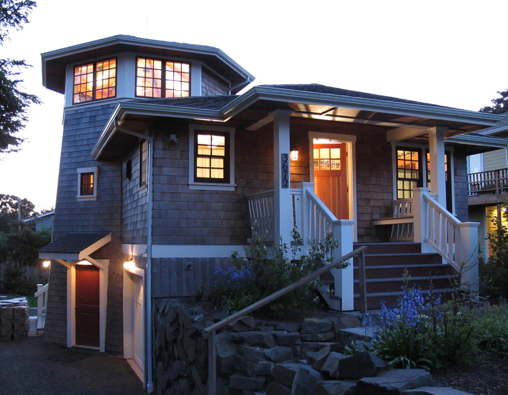 Photo of a mid-sized traditional three-storey grey house exterior in Portland with wood siding, a hip roof and a shingle roof.