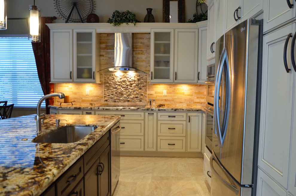 Example of a mid-sized transitional l-shaped open concept kitchen design in Miami with an undermount sink, flat-panel cabinets, white cabinets, granite countertops, beige backsplash, stone tile backsplash, stainless steel appliances and an island