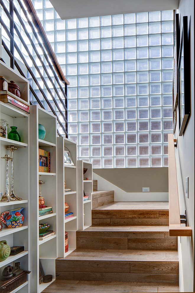 This is an example of a contemporary wood u-shaped staircase in Portland with wood risers.
