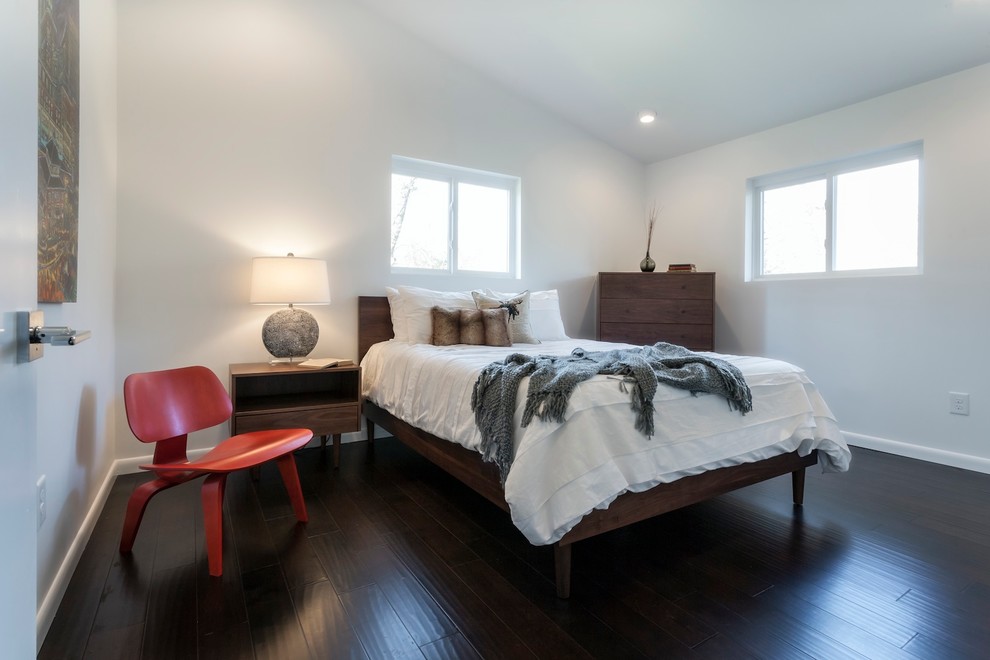 Mid-sized midcentury master bedroom in Other with white walls, dark hardwood floors and no fireplace.