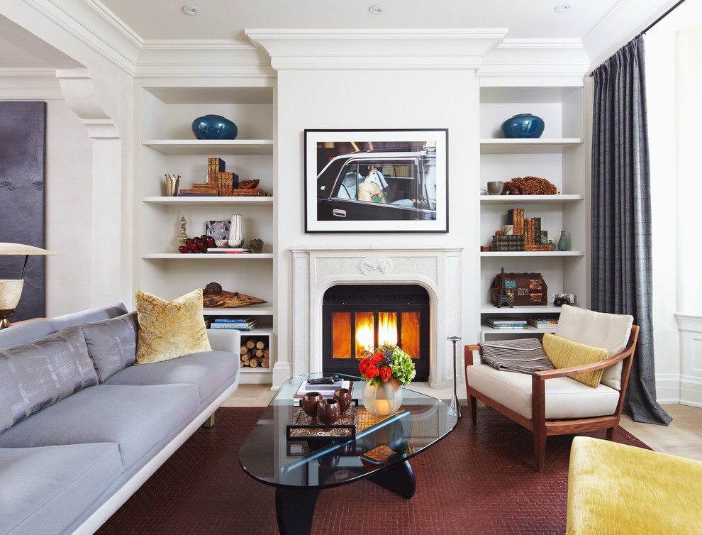 This is an example of a mid-sized transitional formal enclosed living room in Toronto with white walls, a standard fireplace, travertine floors, a metal fireplace surround and no tv.