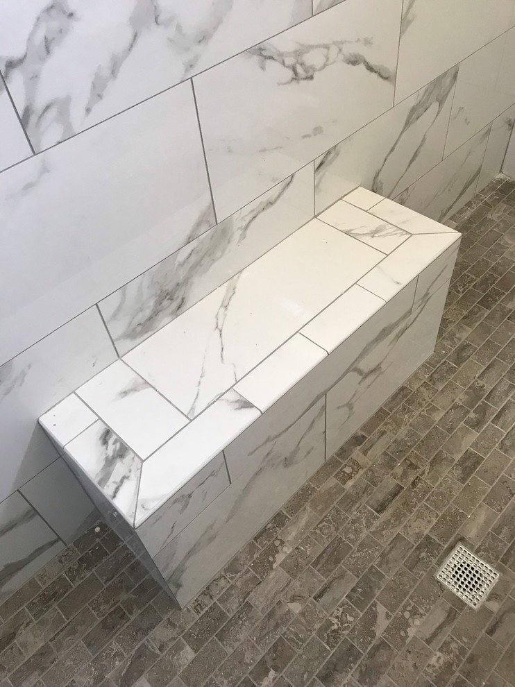 Photo of a large transitional master bathroom in Dallas with a double shower, porcelain floors, grey floor, shaker cabinets, black cabinets, a two-piece toilet, white tile, marble, beige walls, an undermount sink, solid surface benchtops, an open shower and white benchtops.
