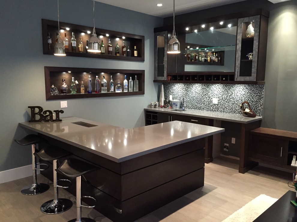 Design ideas for a large contemporary u-shaped seated home bar in Vancouver with an undermount sink, dark wood cabinets, solid surface benchtops, blue splashback, mosaic tile splashback and light hardwood floors.