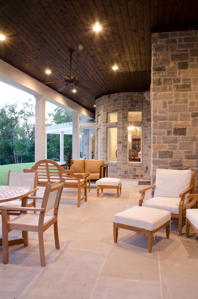 Large traditional backyard verandah in Austin with tile and a roof extension.