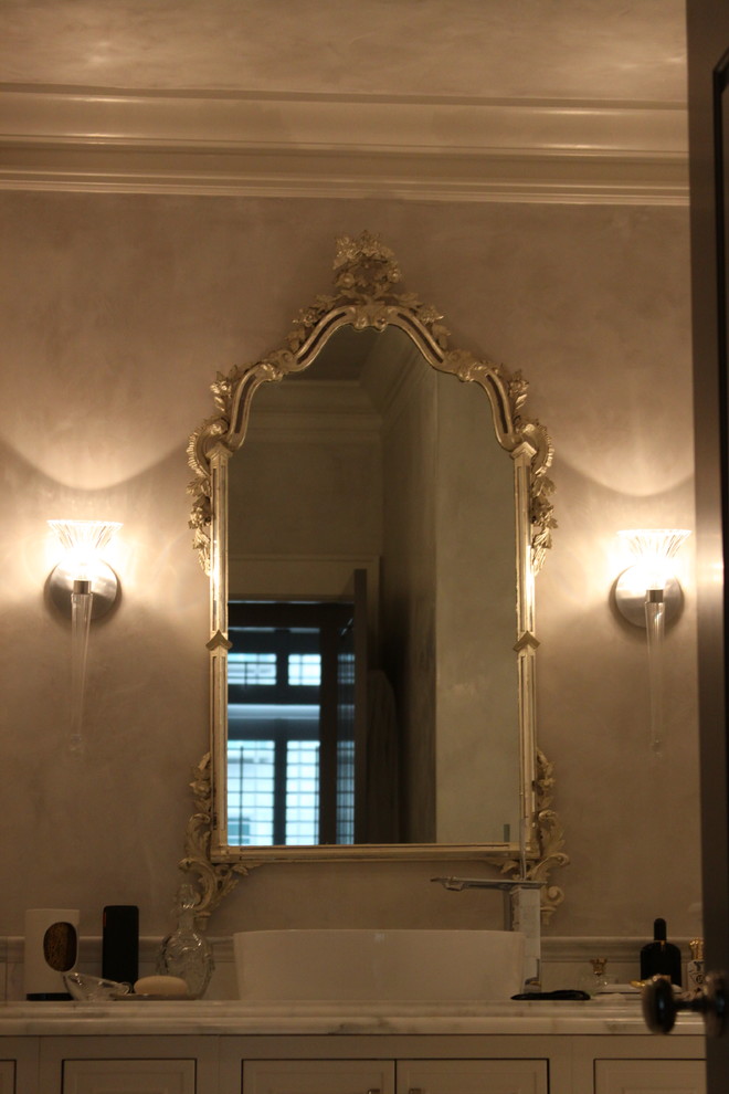 Example of a mid-sized transitional master multicolored tile and stone tile marble floor freestanding bathtub design in Atlanta with a vessel sink, beaded inset cabinets, beige cabinets, marble countertops, a one-piece toilet and gray walls