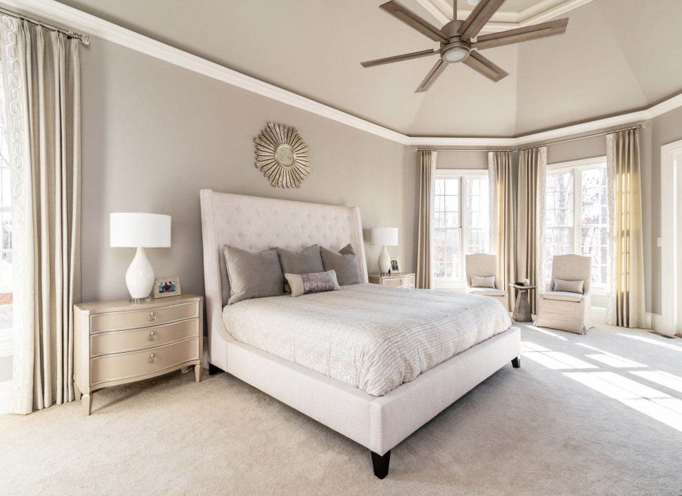 Photo of a large transitional master bedroom in Charlotte with grey walls, carpet, a two-sided fireplace, a tile fireplace surround and recessed.