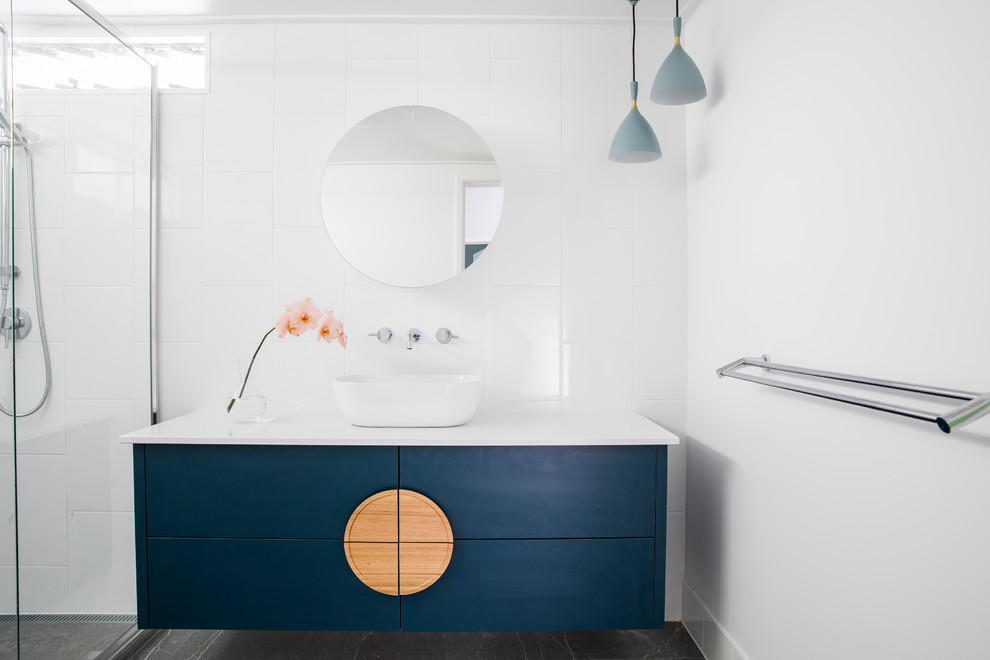 Inspiration for a mid-sized contemporary kids bathroom in Townsville with flat-panel cabinets, blue cabinets, white tile, ceramic tile, ceramic floors, grey floor, a hinged shower door, a vessel sink and white benchtops.