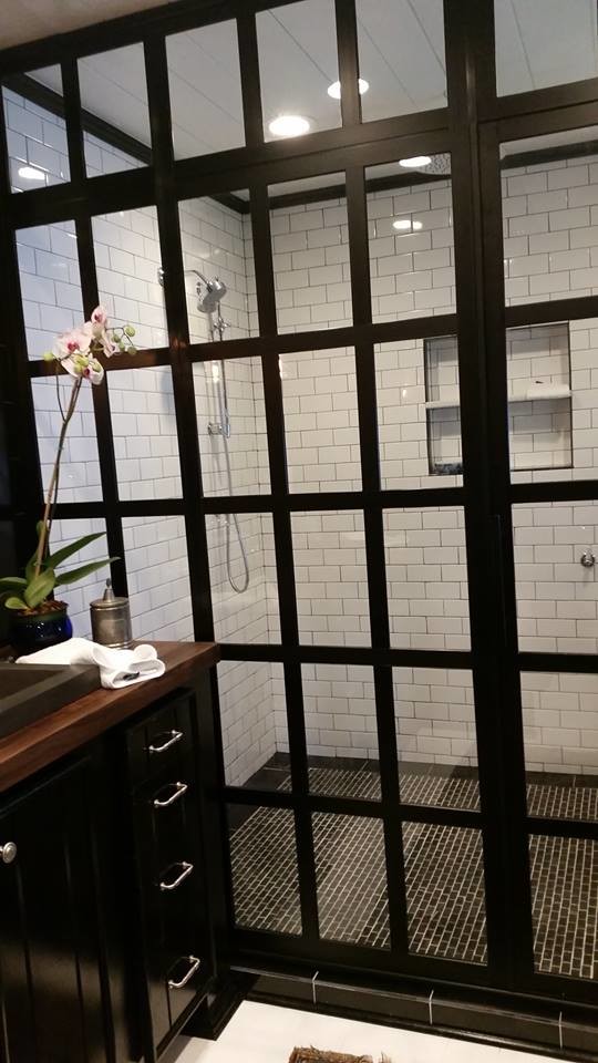 Contemporary bathroom in Other with flat-panel cabinets, black cabinets, an alcove shower, black and white tile, porcelain tile, black walls, porcelain floors, a trough sink and wood benchtops.