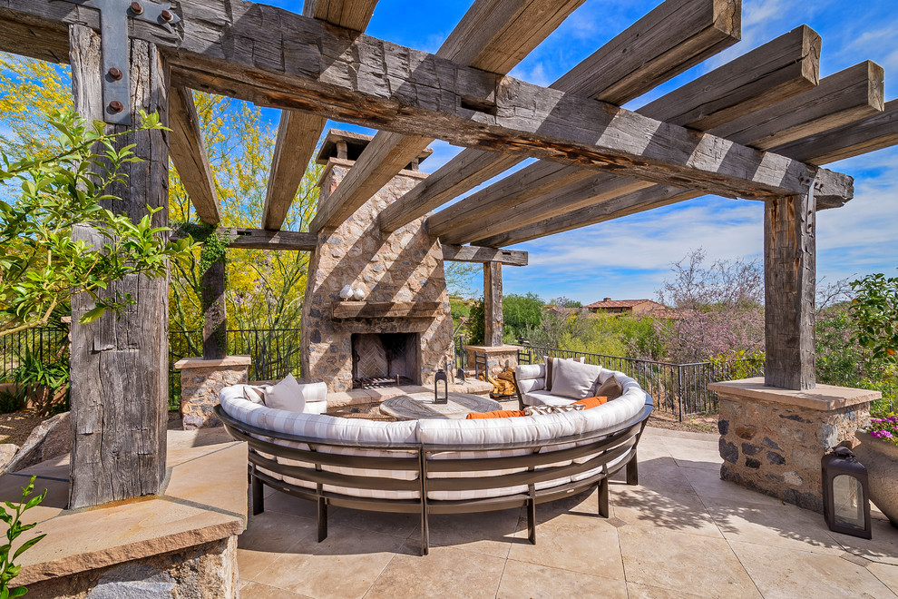 Design ideas for a patio in Phoenix with a pergola and with fireplace.