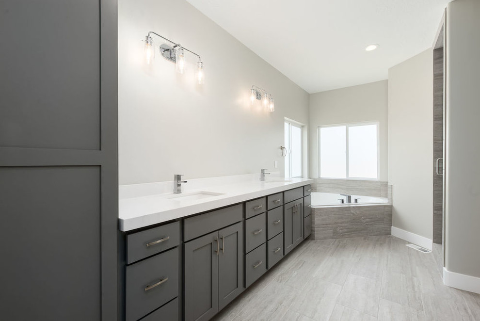 Design ideas for a large arts and crafts master bathroom in Salt Lake City with shaker cabinets, green cabinets, an alcove tub, an alcove shower, a two-piece toilet, gray tile, ceramic tile, grey walls, laminate floors, an undermount sink, granite benchtops, grey floor, a shower curtain and white benchtops.