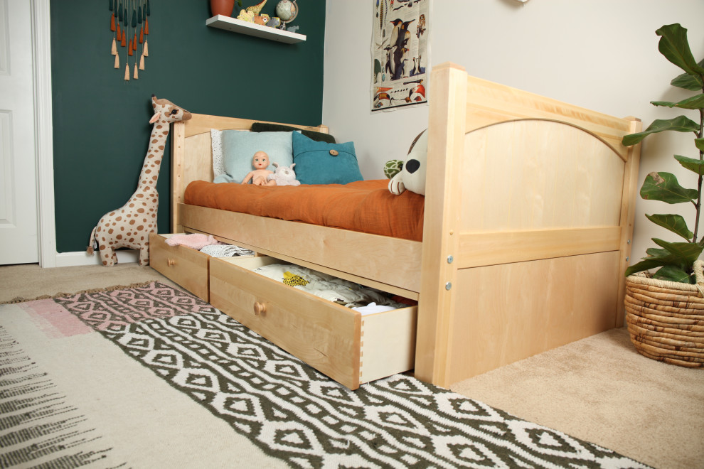 This is an example of a small modern gender neutral toddler’s room in Other with green walls.