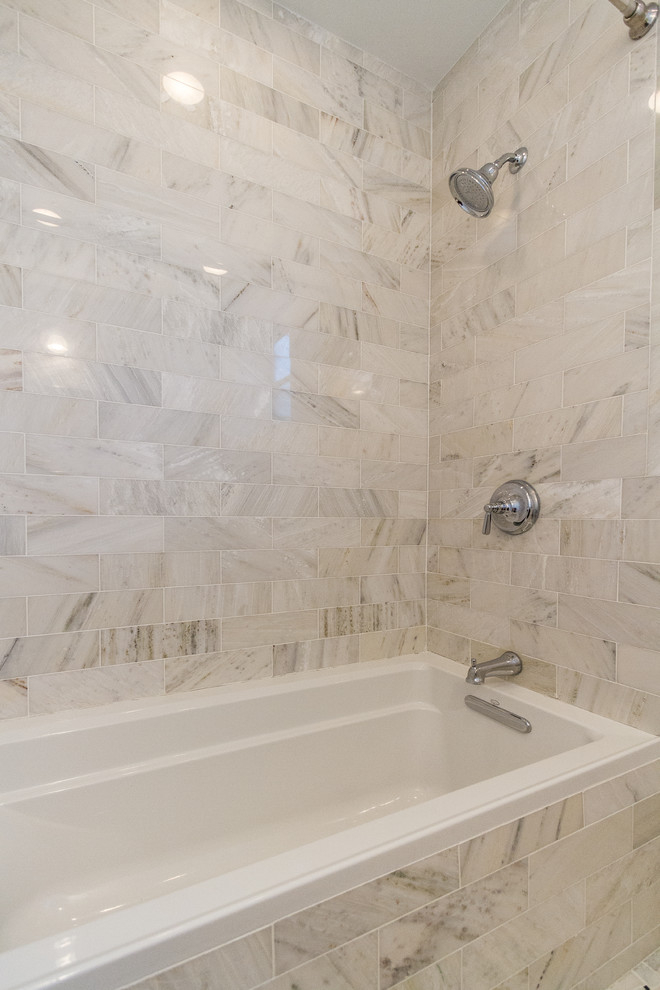 This is an example of a small traditional master bathroom in New York with shaker cabinets, white cabinets, an alcove tub, a shower/bathtub combo, beige tile, marble, beige walls, an undermount sink, solid surface benchtops and an open shower.