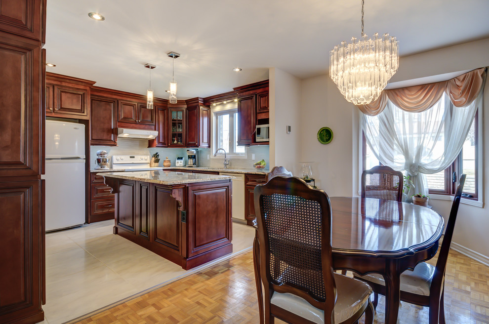 Mid-sized transitional l-shaped porcelain tile eat-in kitchen photo in Montreal with an undermount sink, raised-panel cabinets, dark wood cabinets, granite countertops, beige backsplash, mosaic tile backsplash, white appliances and an island
