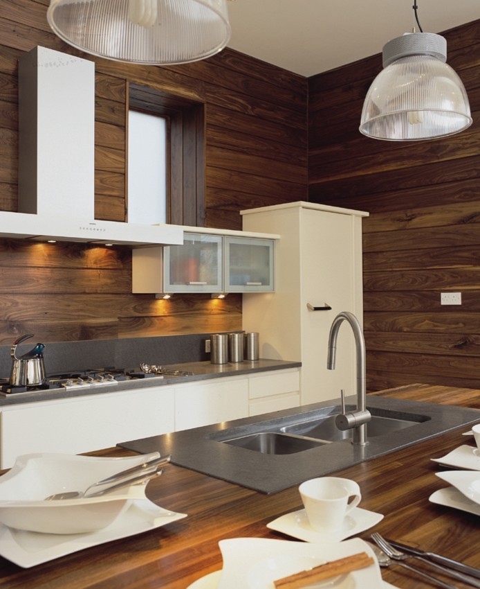Mid-sized modern single-wall eat-in kitchen in London with a double-bowl sink, flat-panel cabinets, white cabinets, wood benchtops, stainless steel appliances, ceramic floors and with island.