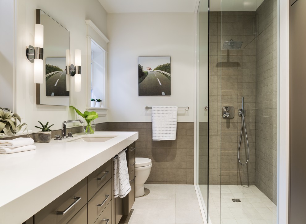 Photo of a small contemporary kids bathroom in Toronto with an undermount sink, flat-panel cabinets, grey cabinets, engineered quartz benchtops, an open shower, a two-piece toilet, gray tile, ceramic tile, white walls and porcelain floors.