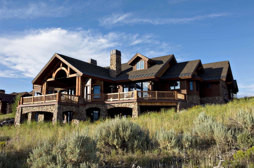 Photo of a large country two-storey exterior in Salt Lake City with wood siding.