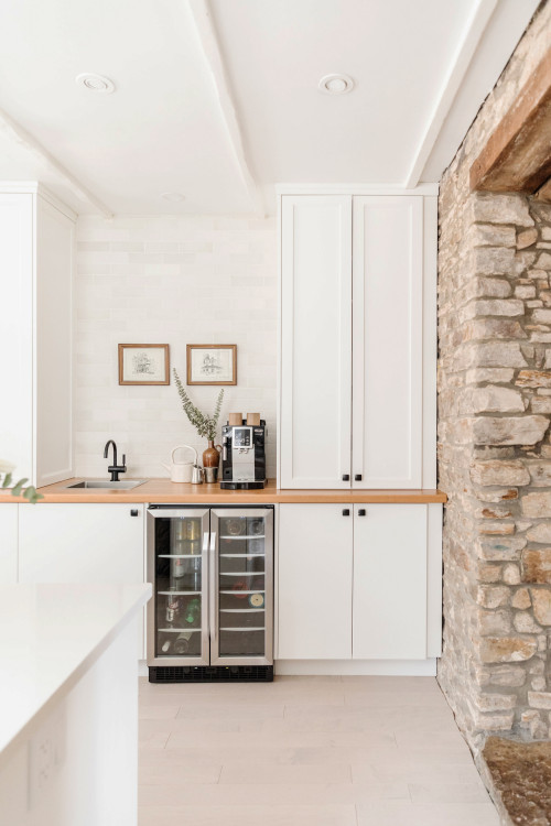 Classic and Elegant: Crisp White Kitchen Cabinetry with Wood Countertop and Black Knobs - Kitchen Coffee Bar Ideas