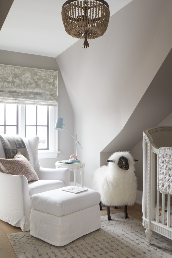Photo of a beach style gender-neutral nursery in Toronto with grey walls and light hardwood floors.